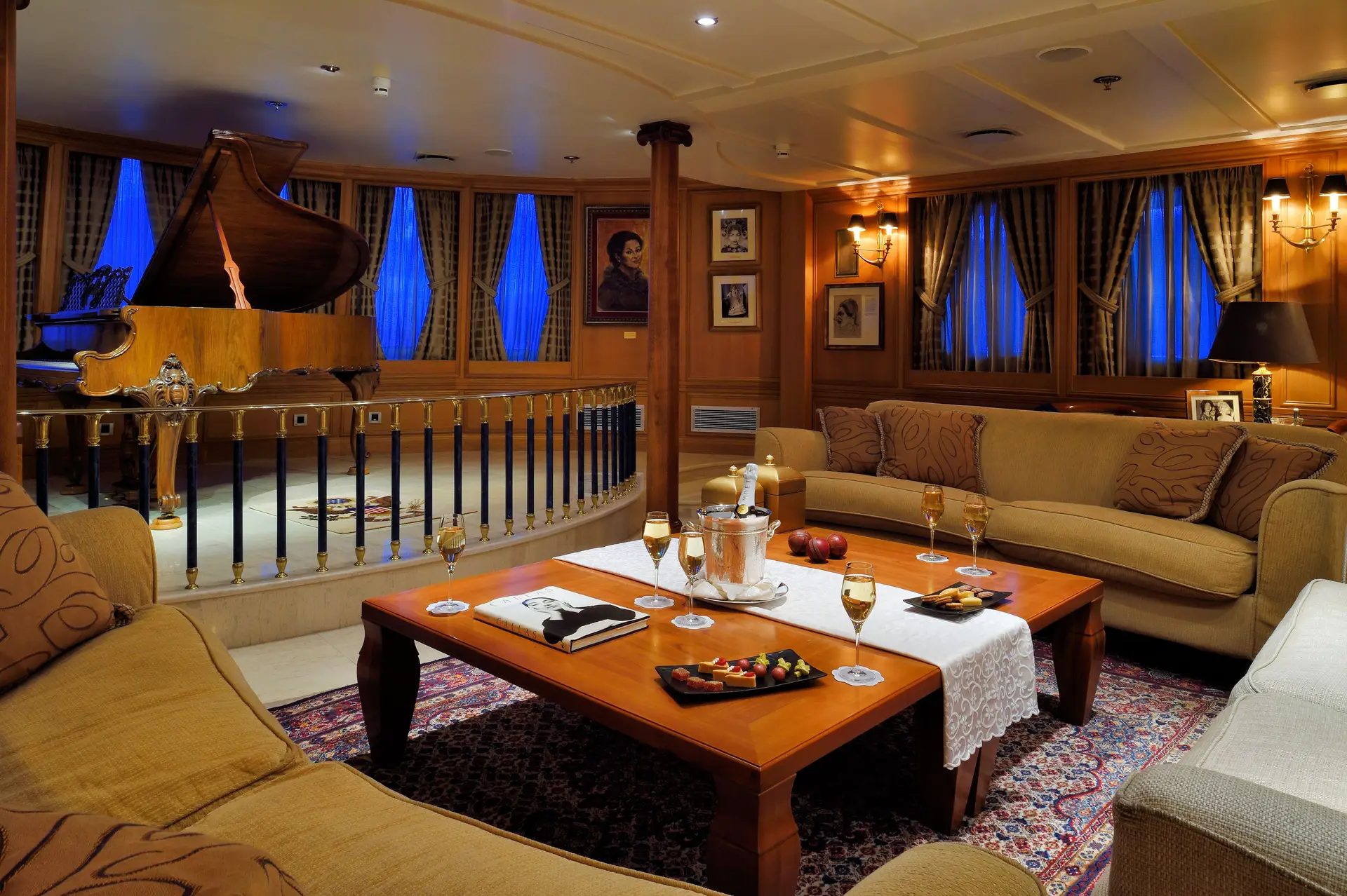 Lounge aboard CHRISTINA O with grand piano on a raised platform