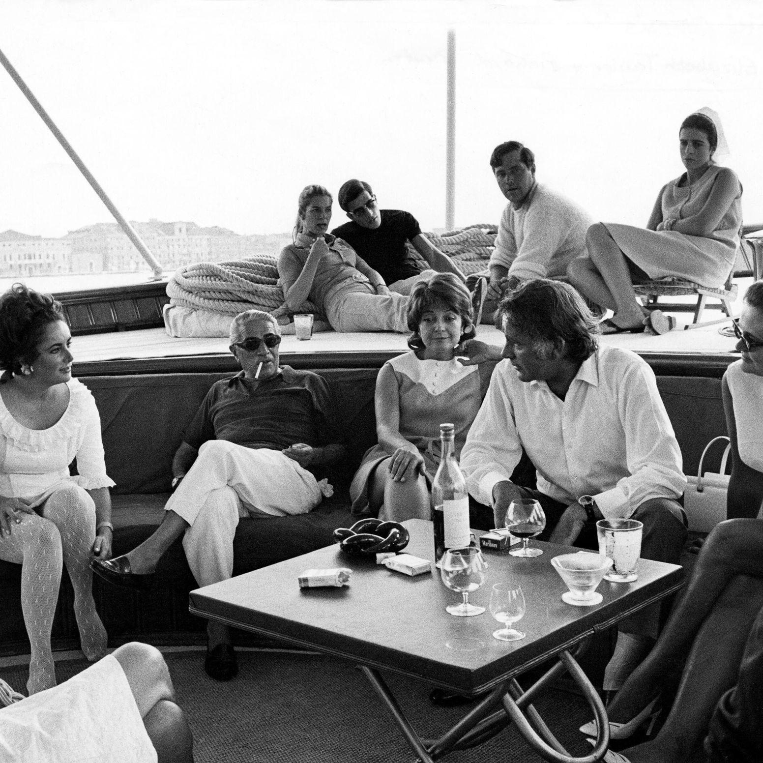 Aristotle Onassis and guests seated on the deck of CHRISTINA in the 1960s