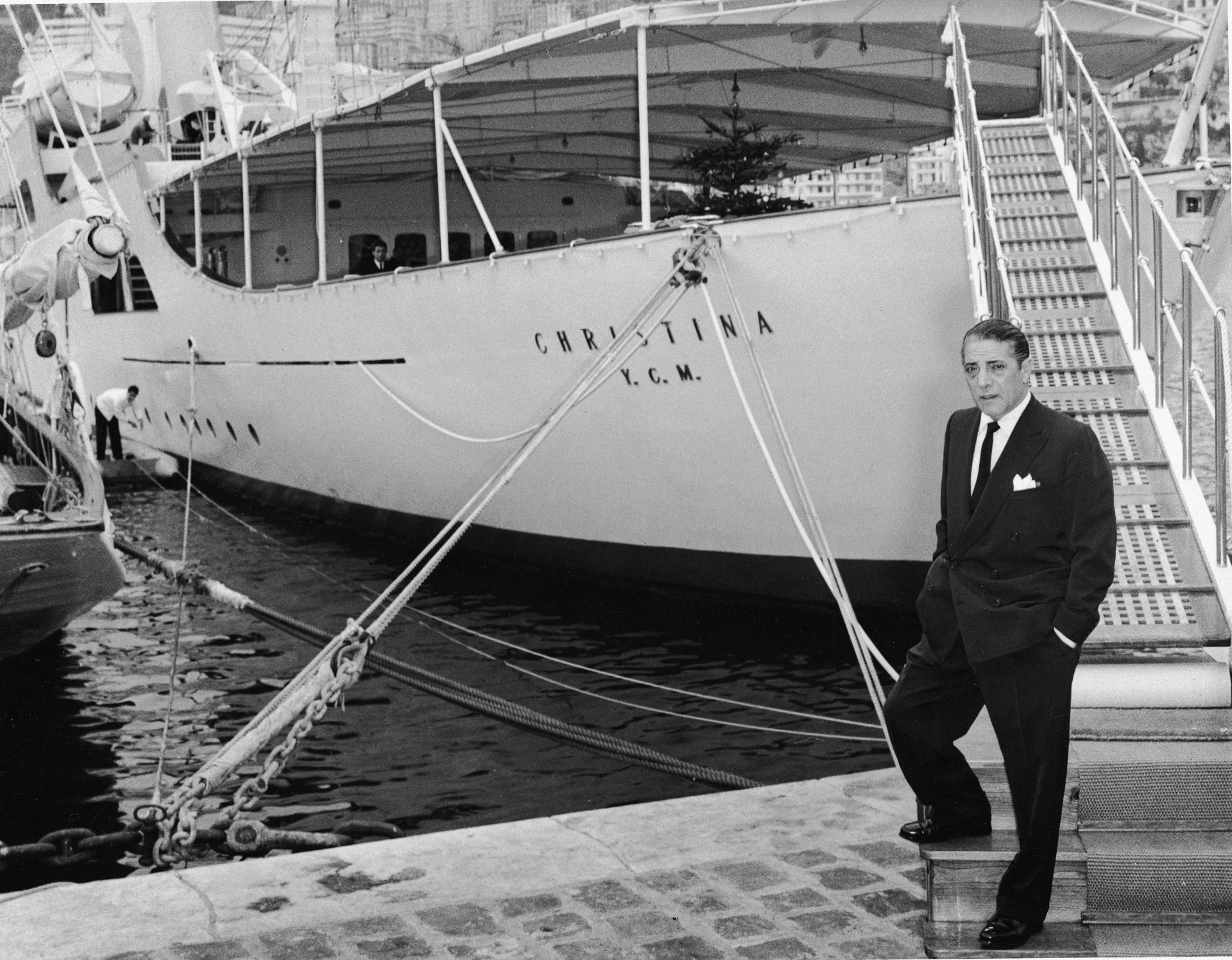 Aristotle Onassis standing at the gangway of the yacht CHRISTINA in Monaco harbour